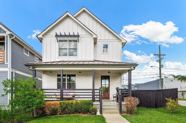 modern farmhouse style home featuring a front yard and covered porch