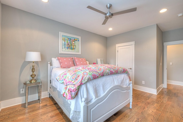 bedroom with wood-type flooring and ceiling fan