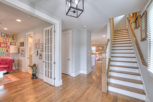 stairs with hardwood / wood-style flooring