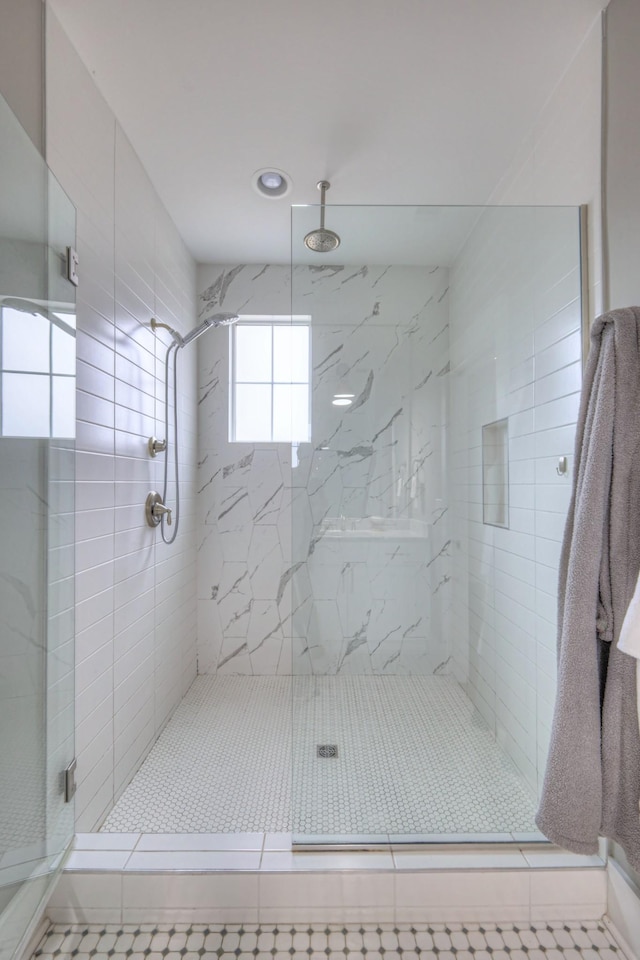 bathroom featuring a shower with door