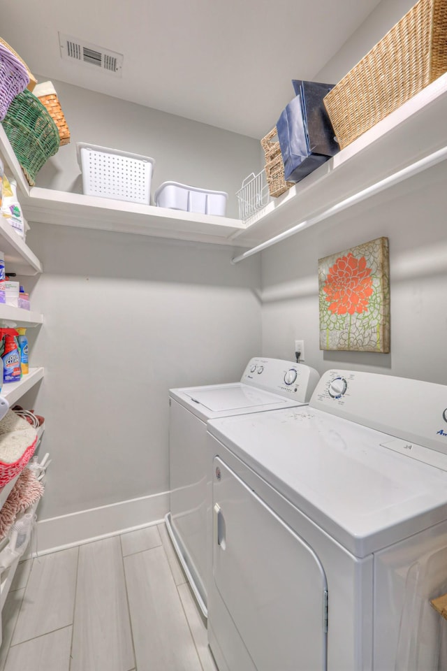 clothes washing area with washer and clothes dryer