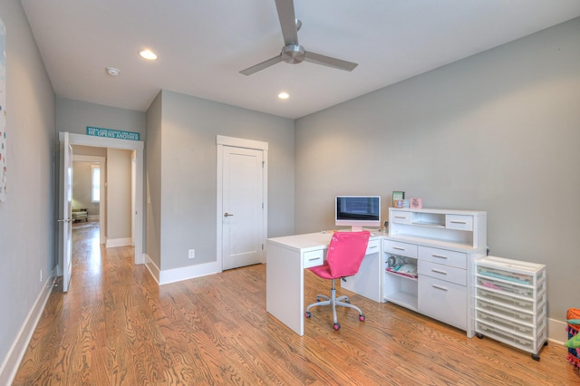 home office with ceiling fan and light hardwood / wood-style floors