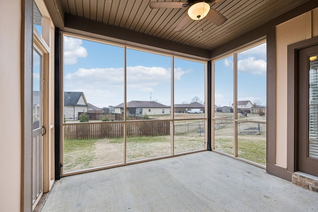 unfurnished sunroom with wood ceiling and ceiling fan