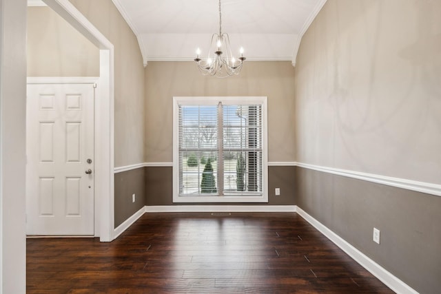 unfurnished dining area featuring ornamental molding, dark wood-type flooring, and a chandelier