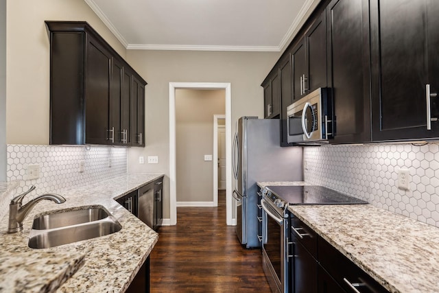 kitchen with crown molding, appliances with stainless steel finishes, light stone countertops, and sink