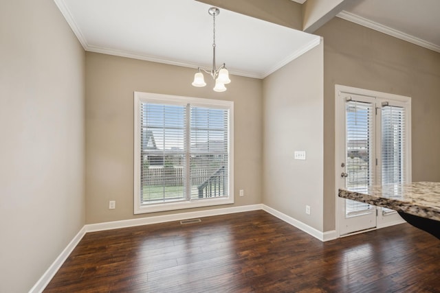 unfurnished dining area featuring ornamental molding, dark wood-type flooring, and a chandelier