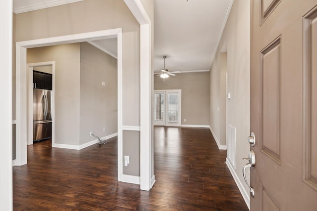 foyer entrance with dark wood-type flooring, ceiling fan, and crown molding