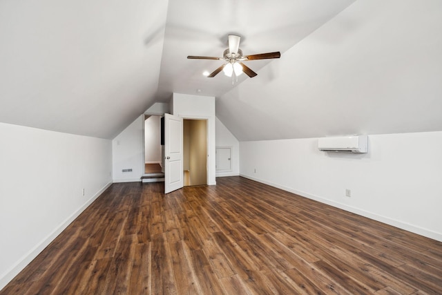 bonus room featuring a wall mounted air conditioner, vaulted ceiling, dark hardwood / wood-style floors, and ceiling fan