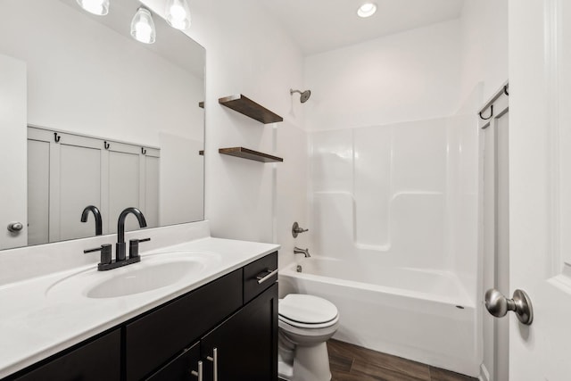 full bathroom featuring  shower combination, toilet, wood-type flooring, and vanity