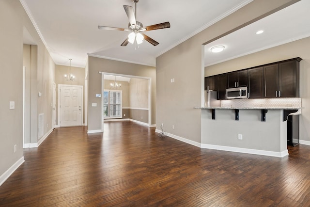 unfurnished living room with ornamental molding, dark hardwood / wood-style floors, and ceiling fan with notable chandelier