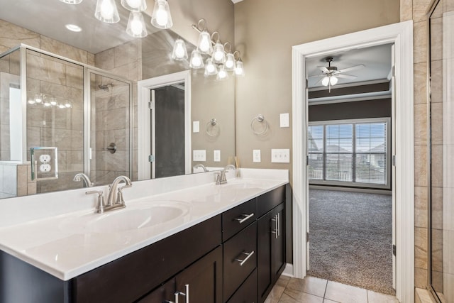 bathroom featuring vanity, tile patterned flooring, a shower with door, and crown molding