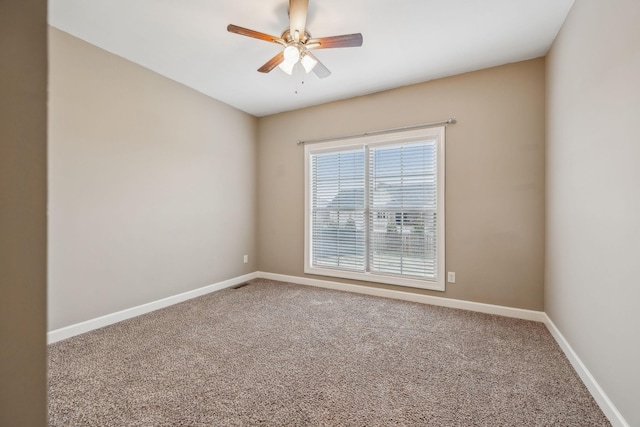 carpeted spare room with ceiling fan