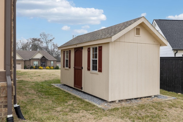 view of outdoor structure featuring a lawn