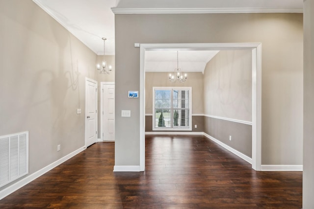 entryway featuring dark hardwood / wood-style flooring, ornamental molding, and an inviting chandelier