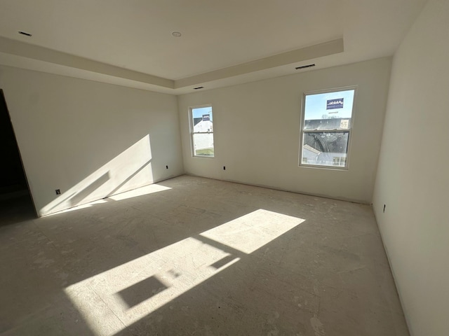 empty room featuring a raised ceiling