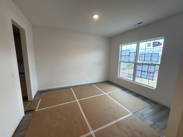 empty room with hardwood / wood-style flooring