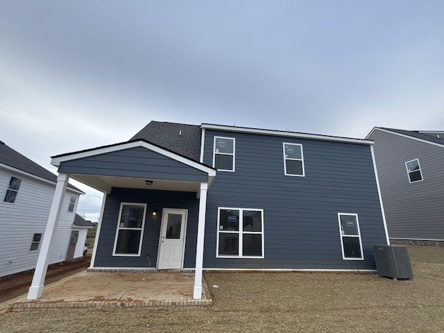 rear view of property featuring a patio area and central air condition unit