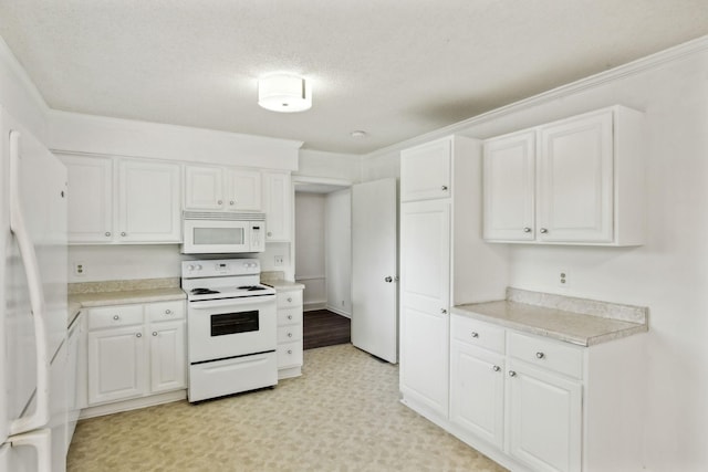 kitchen featuring white cabinetry, ornamental molding, a textured ceiling, and white appliances