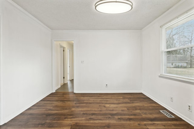 unfurnished room featuring ornamental molding, dark hardwood / wood-style floors, and a textured ceiling