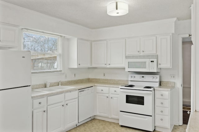 kitchen featuring white cabinetry, sink, a textured ceiling, and white appliances