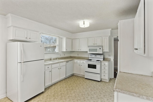 kitchen with white cabinetry, sink, a textured ceiling, and white appliances