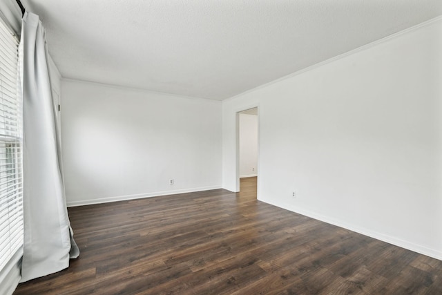 spare room with crown molding, dark hardwood / wood-style floors, and a textured ceiling