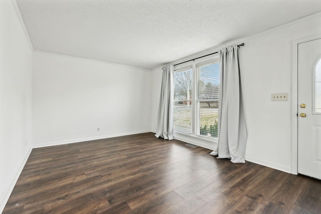 foyer entrance featuring dark hardwood / wood-style floors and a textured ceiling