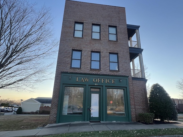 view of outdoor building at dusk