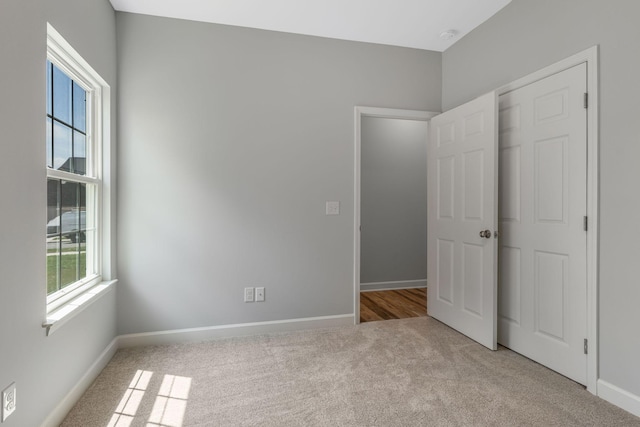 unfurnished bedroom with light colored carpet