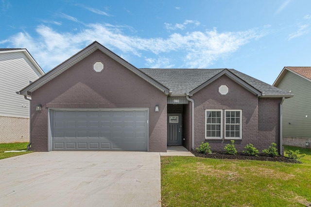 ranch-style house featuring a garage and a front lawn