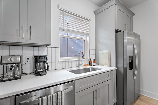 kitchen with sink, gray cabinets, wine cooler, stainless steel fridge with ice dispenser, and decorative backsplash