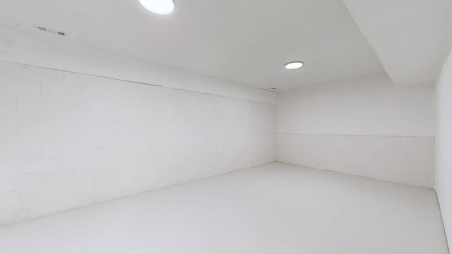 unfurnished room with concrete floors