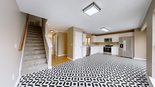 kitchen with white cabinetry, sink, and stainless steel appliances