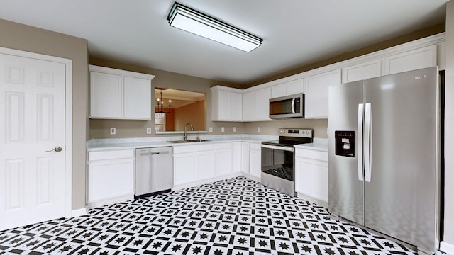 kitchen with white cabinetry, appliances with stainless steel finishes, and sink