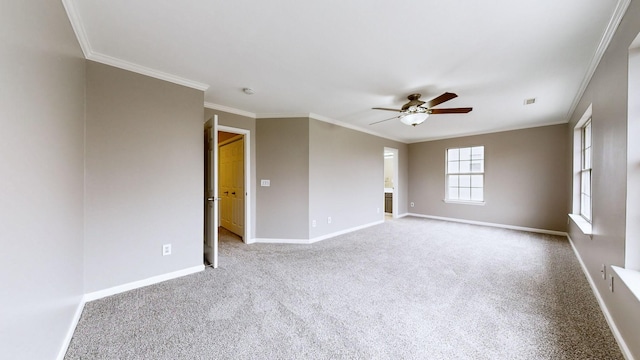 carpeted empty room with crown molding and ceiling fan