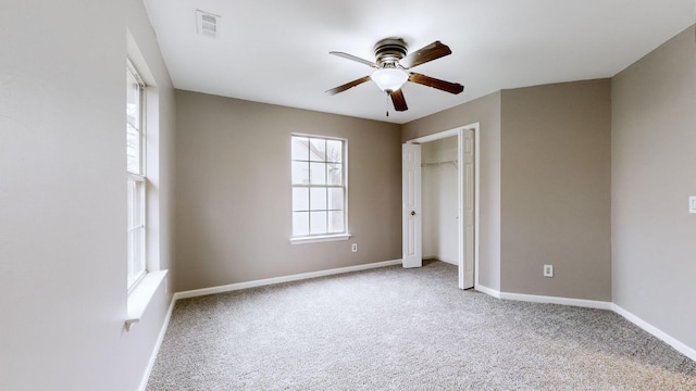 unfurnished bedroom with light carpet, ceiling fan, and a closet