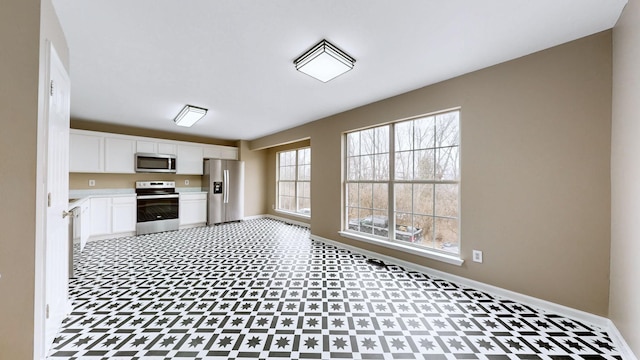 kitchen with white cabinets and appliances with stainless steel finishes