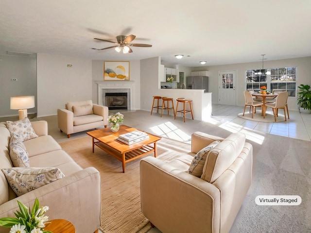 tiled living room featuring a premium fireplace and ceiling fan