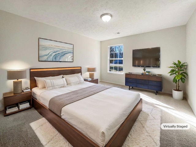 carpeted bedroom with a textured ceiling