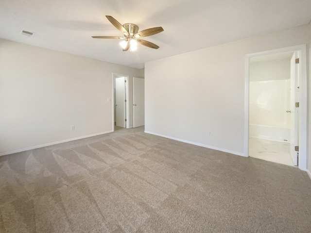 empty room with ceiling fan and carpet flooring