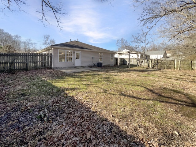 rear view of house featuring cooling unit, a gazebo, a lawn, and a patio