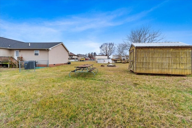 view of yard with an outbuilding and an outdoor fire pit