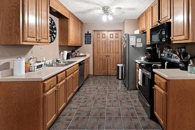 kitchen with sink, a textured ceiling, stainless steel appliances, and ceiling fan