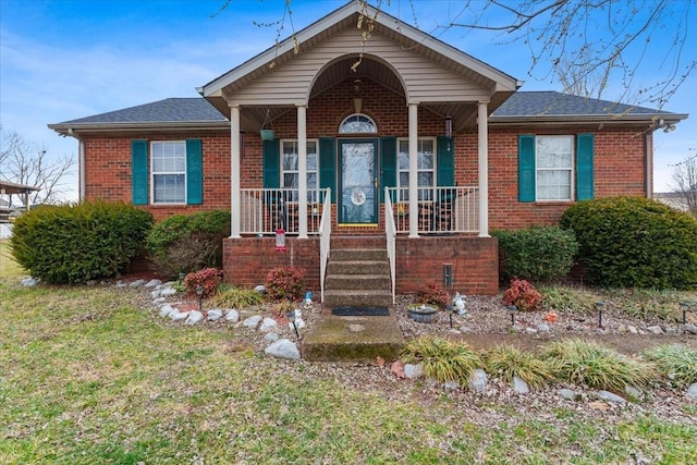 bungalow-style house with a porch and a front lawn