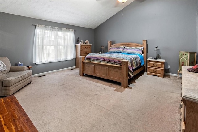 carpeted bedroom with ceiling fan and lofted ceiling