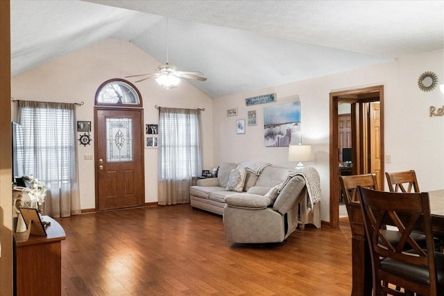 living room featuring ceiling fan, lofted ceiling, and hardwood / wood-style floors