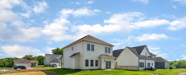 back of property with a garage and a lawn