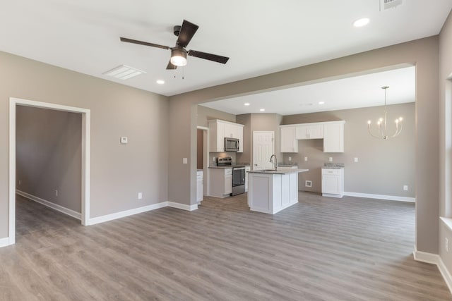 kitchen with sink, white cabinets, stainless steel appliances, a center island with sink, and light wood-type flooring