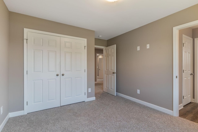 unfurnished bedroom featuring carpet and a closet