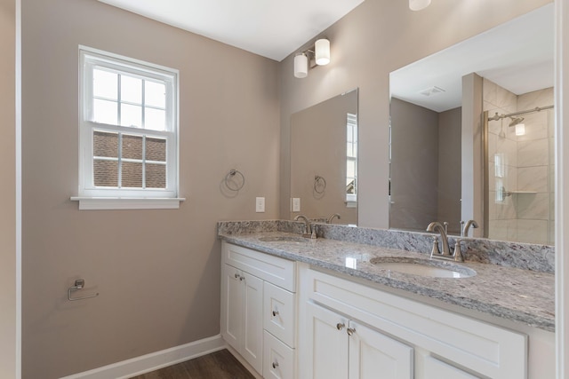 bathroom featuring vanity, a shower with shower door, and wood-type flooring